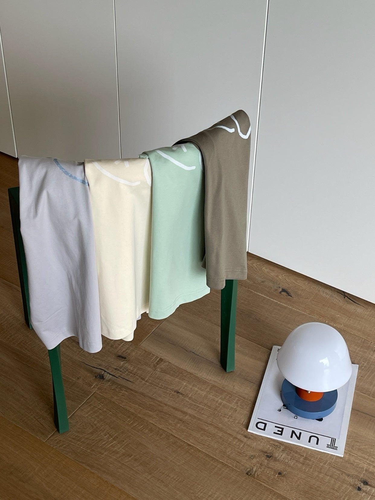Folded Wipeaway 245g cotton-blend tees showing the minimalist puppy logo, perfect for everyday casual streetwear.