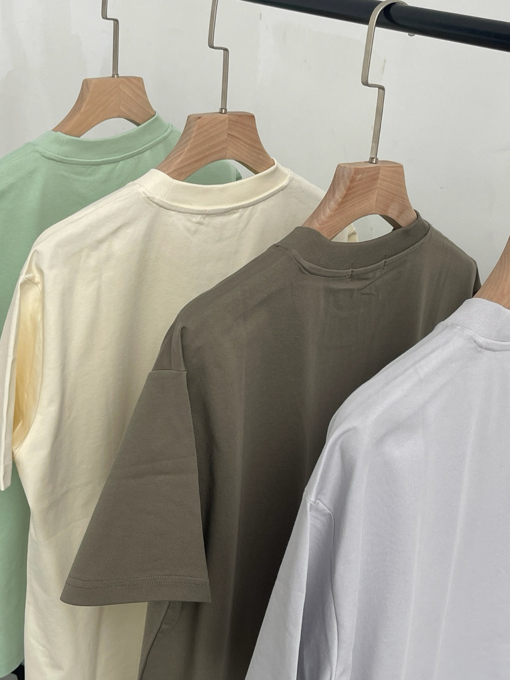 Wipeaway minimalist puppy graphic tees hanging on a rack, showcasing the comfortable loose fit.