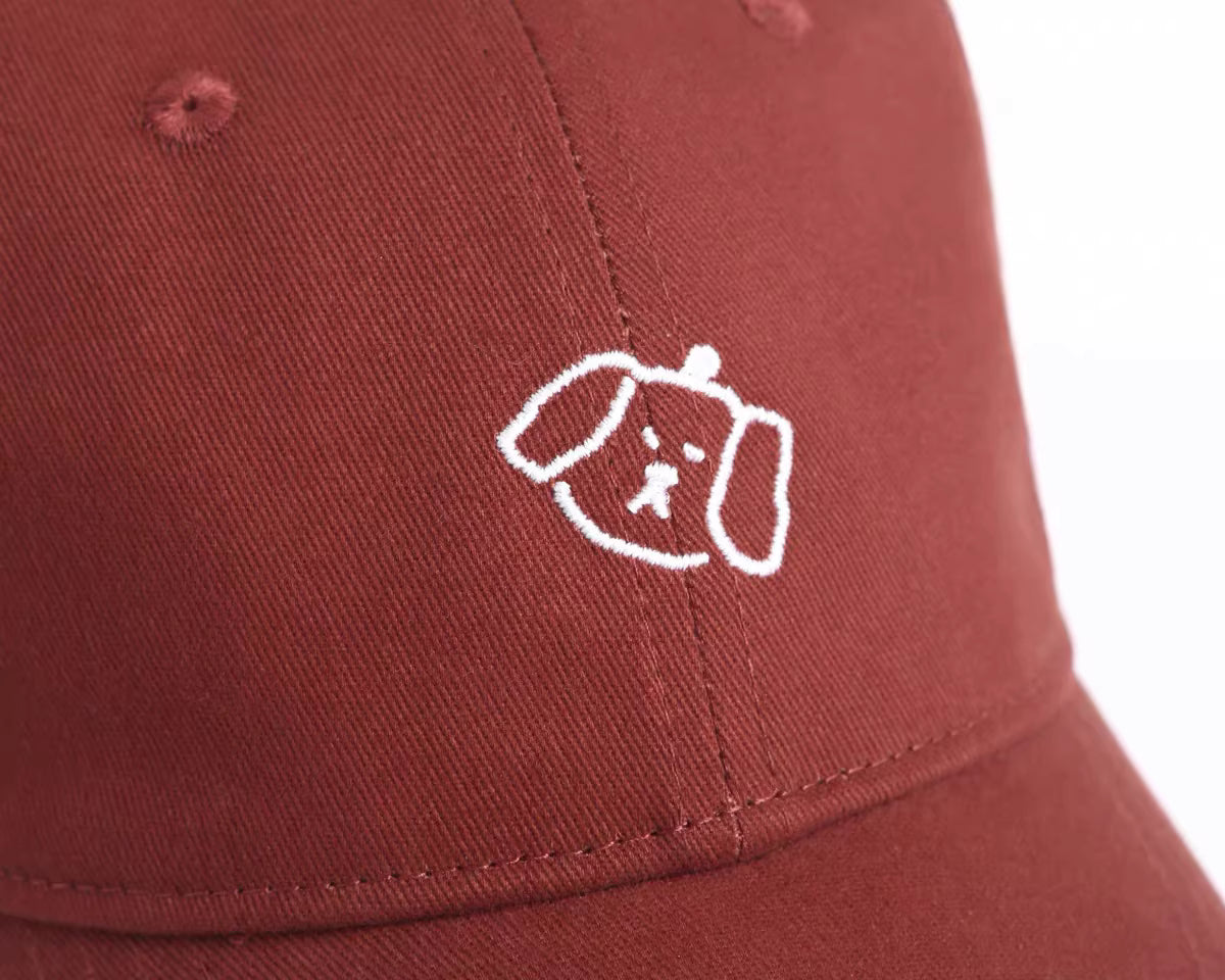 Embroidered puppy logo close-up on baseball cap